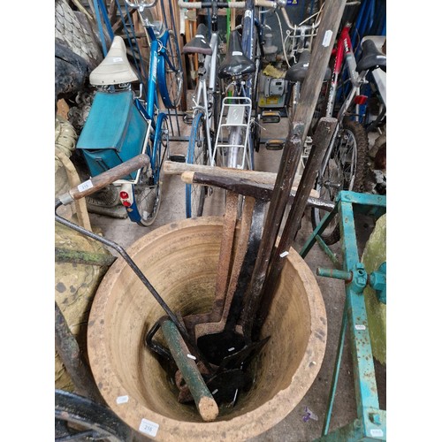 215 - A quantity of vintage farming tools to include silage cutter, turfing spade & a clay spade etc.