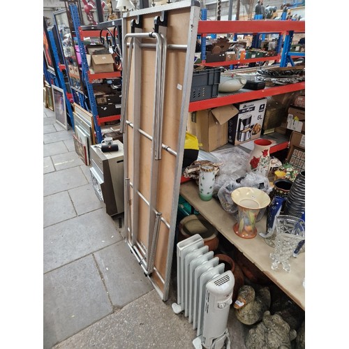 221 - 2 bundles of garden tools, step ladders, trestle table, trolly jack & an electric heater