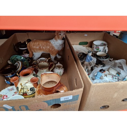 284 - Two boxes of mixed pottery and ornaments including porcelain figures, Goss crested ware, etc.