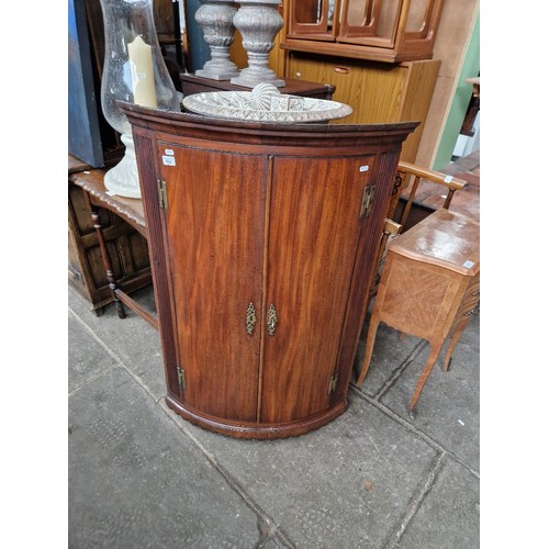 924 - A Georgian mahogany corner cabinet together with an oak occasional table.