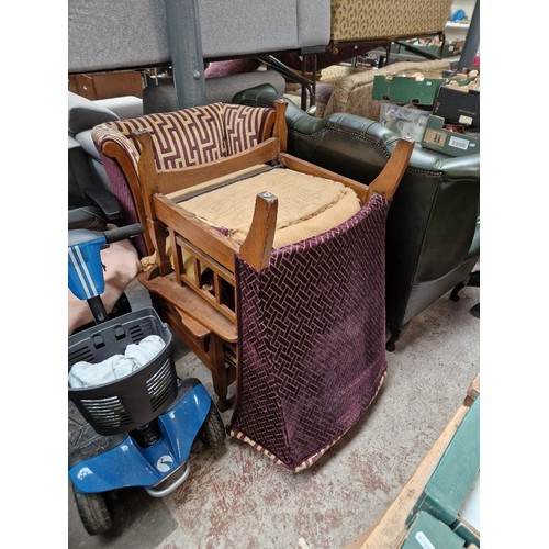 942 - A pair of oak framed wingback armchairs with patterned upholstery.