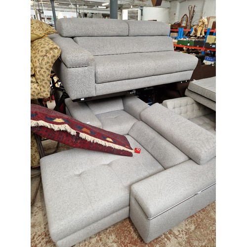 938 - A modern grey L shaped sofa and matching armchair by VyM.