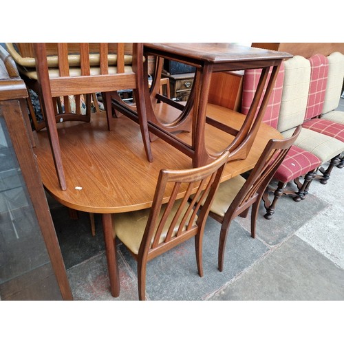 931 - A mid 20th century G Plan teak extending dining table and six chairs.