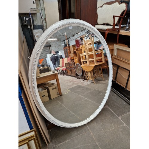 952 - A large white framed oval wall mirror, 133cm x 165cm (approx).