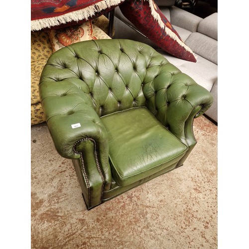 953 - A green leather Chesterfield club chair.