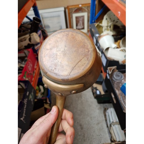 285 - A box of metalware including Swiss copper pan, Victorian and later pans, enamelled, etc.