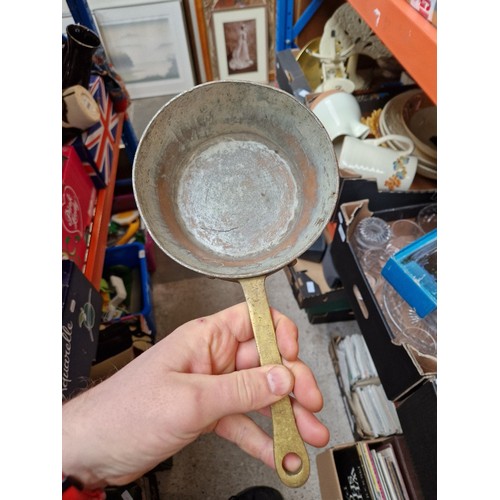 285 - A box of metalware including Swiss copper pan, Victorian and later pans, enamelled, etc.