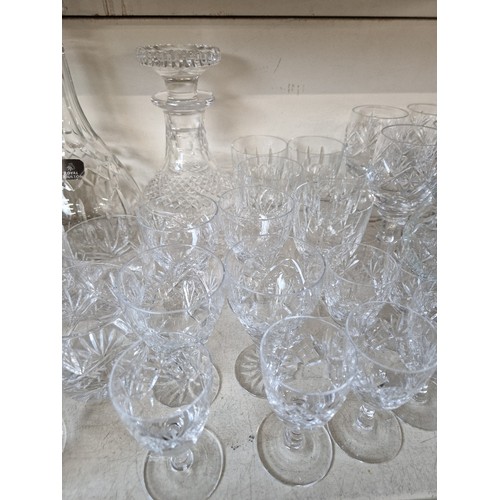 565 - Lead crystal - Royal Doulton decanter and another decanter, 34 glasses including makers such as Edin... 