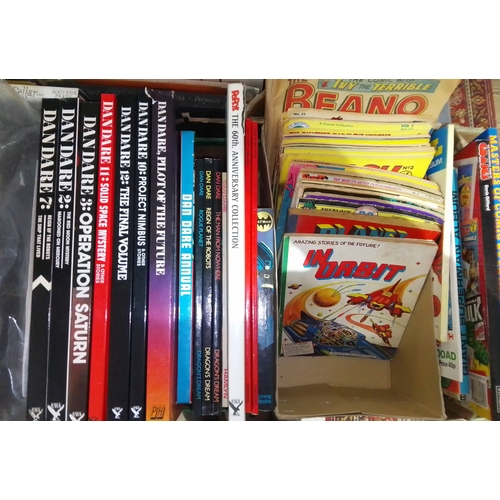 229 - A box of assorted comics and hardback comic illustration books, including Dan Dare Deluxe Collector'... 