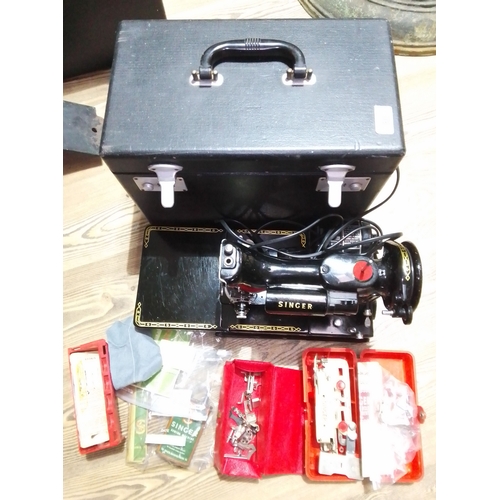 80 - A Singer 222K Featherweight sewing machine, cased with accessories including button holer, various f... 