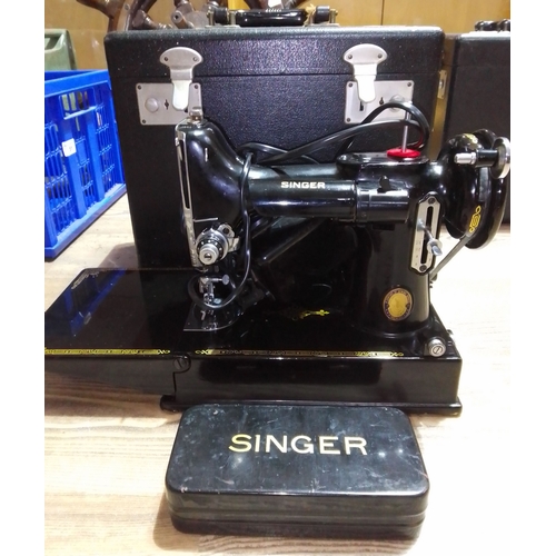 81 - A Singer Featherweight electric travel sewing machine with case.