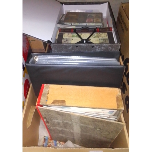 253 - A box of assorted mint presentation packs and FDCs etc.