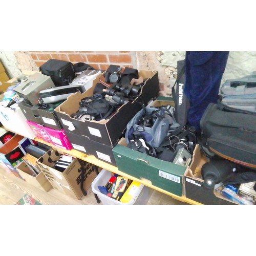 294 - Seven boxes of assorted camera equipment and binoculars.