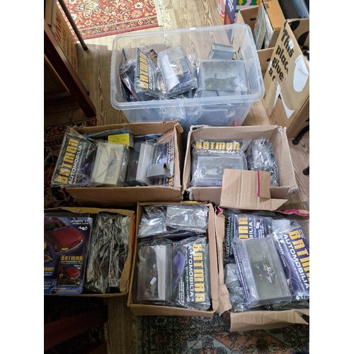 355 - A large collection of Batman automobilia model vehicles, boxed with magazines (un-opened).