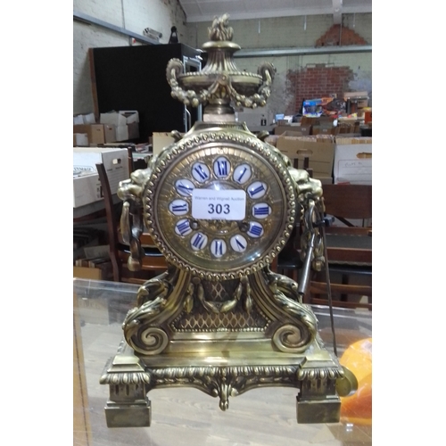 303 - An Ormolu French bronze mantle clock by H & F, Paris, complete with pendulum and key, height 32cm.