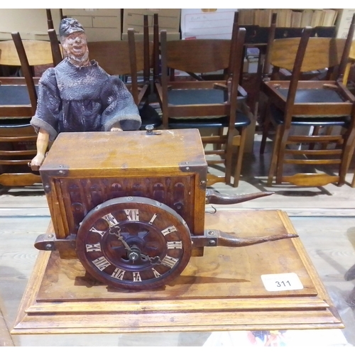 311 - A novelty automaton clock, modelled as an organ cart operated by a carved wood man, on platform base... 