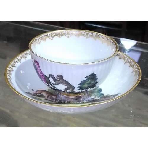 325 - A Meissen cup and saucer, circa 1800, hand painted decoration depicting a monkey, a horse, a dog and... 