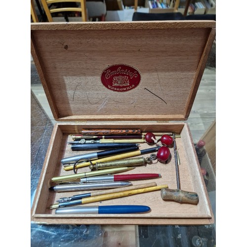 408 - A cigar box and containing various collectables including Parker pens, dip pens, beads, etc.