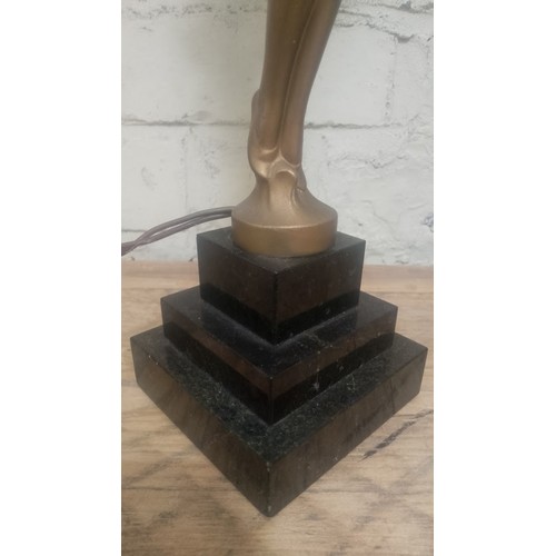 87 - An Art Deco bronze effect table lamp, height 44cm.