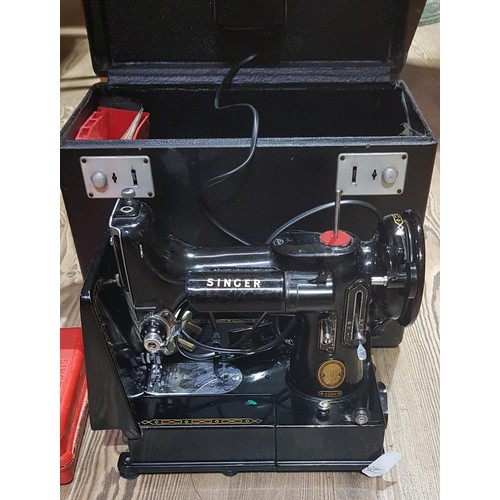 80 - A Singer 222K Featherweight sewing machine, cased with accessories including button holer, various f... 