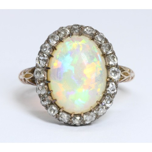 3 - An antique opal and diamond ring, circa 1900, the opal cabochon measuring approximately 14.20 mm x 1... 