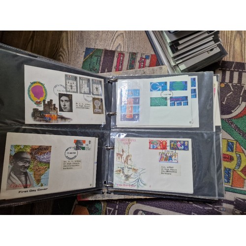 253 - A box of assorted mint presentation packs and FDCs etc.