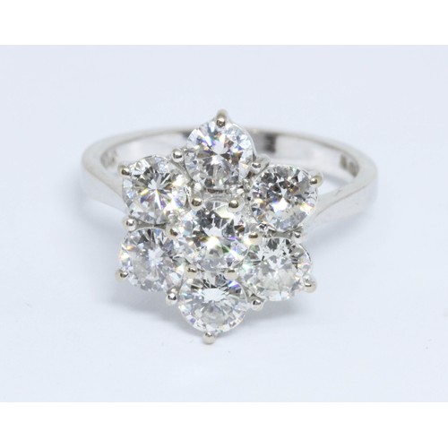 55 - A seven stone diamond cluster ring, the daisy head cluster measuring approximately 15.12mm x 13.04mm... 