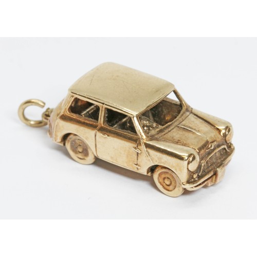 72 - A 9ct gold charm modelled as a 1959 Morris Mini-Minor, hinged and opening to reveal a driver, sponso... 