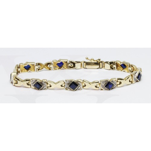 132 - A synthetic sapphire and colourless stone bracelet, marked '585', length 19cm, gross weight 16.1g.