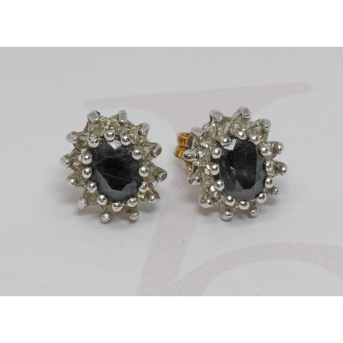 134 - A pair of sapphire and colourless stone cluster ear studs, one pin hallmarked 9ct gold, gross weight... 