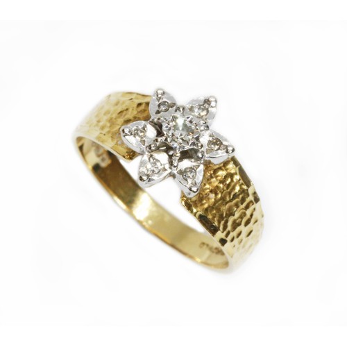 127 - A hallmarked 18ct gold diamond cluster ring, the flower head cluster measuring approximately 10mm in... 