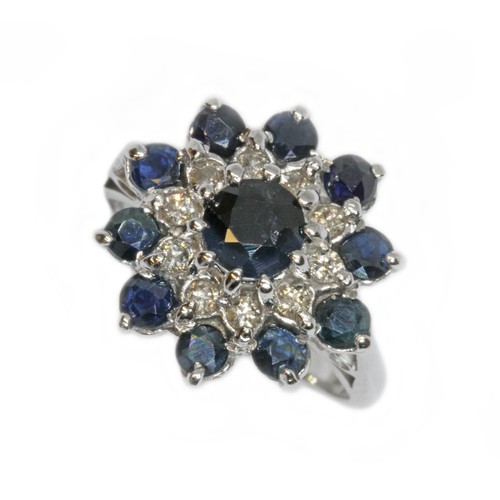 124 - A diamond and sapphire cluster ring, the cluster measuring approximately 16mm in diameter, white met... 