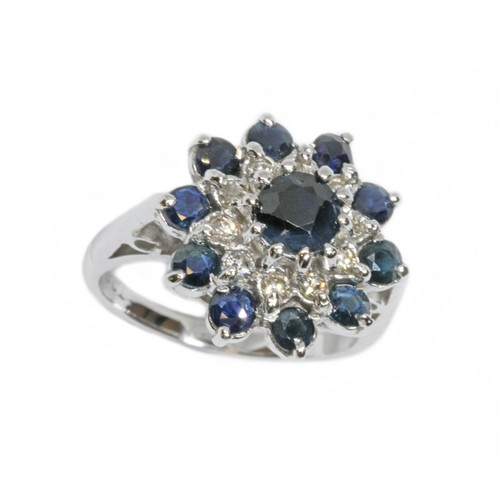 124 - A diamond and sapphire cluster ring, the cluster measuring approximately 16mm in diameter, white met... 