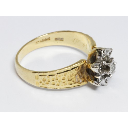 127 - A hallmarked 18ct gold diamond cluster ring, the flower head cluster measuring approximately 10mm in... 