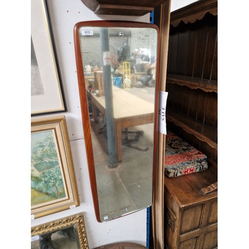 815 - A mid 20th century teak framed wall mirror, 36cm x 96cm.