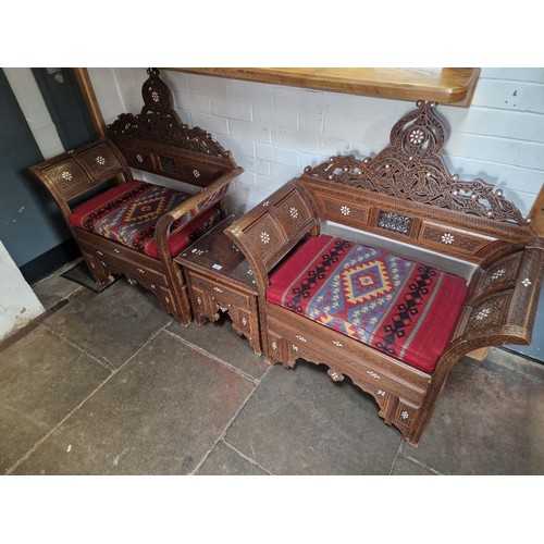 859 - A pair of Moorish carved hardwood and mother of pearl inlaid armchairs & matching table.