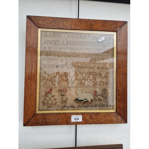 834 - A 19th century sampler, dated 1845, framed and glazed 37cm x 38cm (overall).