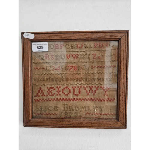 839 - A 19th century sampler, dated 1823, framed and glazed, 24.5cm x 23cm (overall).