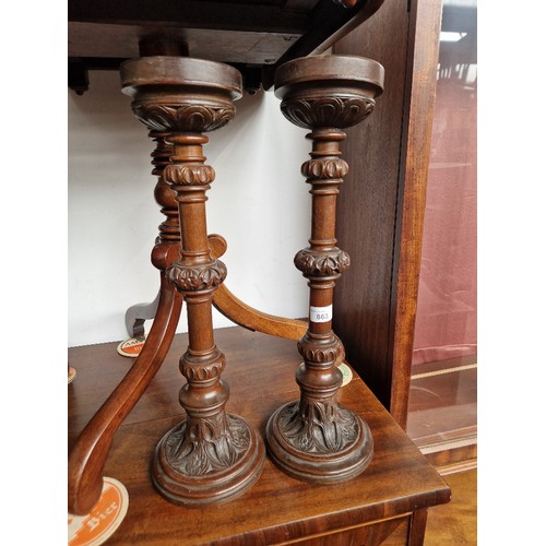 863 - A pair of early 20th century carved oak candle sticks.