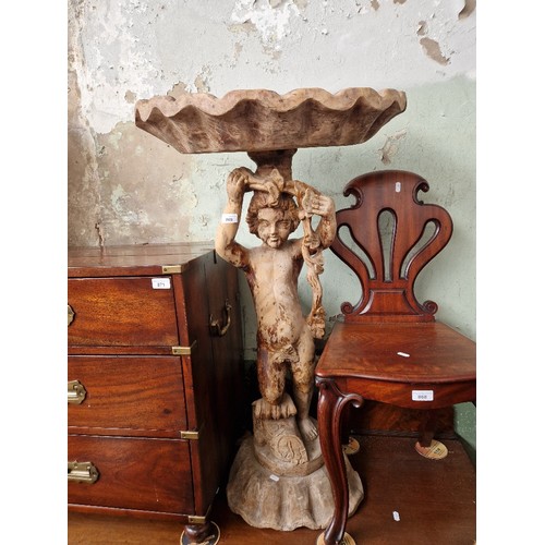 869 - An antique Italian carved wood putti with half clam shell above his head, height 101cm.