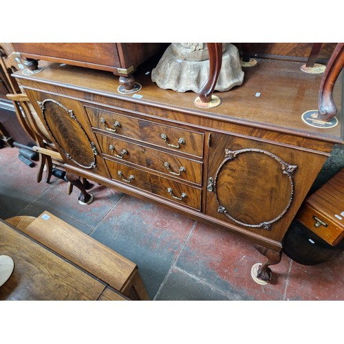 870 - An early 20th century mahogany sideboard on ball and claw feet.