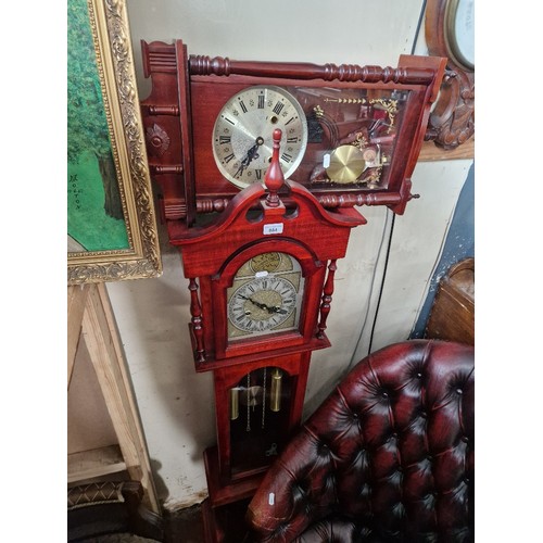 884 - A reproduction granddaughter clock and a reproduction wall clock.