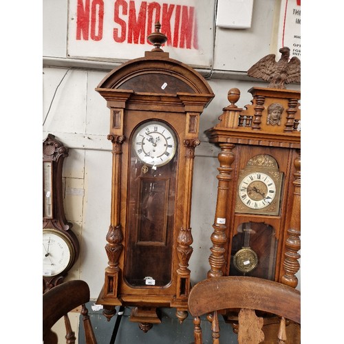 882 - A walnut cased three weight Vienna wall clock, complete with weights, pendulum and key.