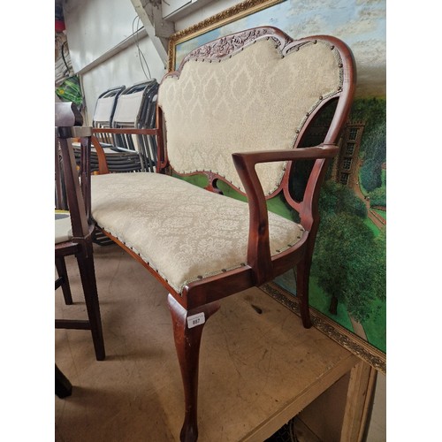 887 - An early 20th century mahogany framed two seater settee.