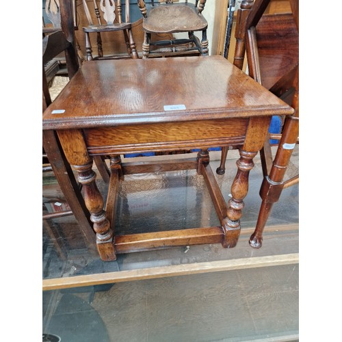 895 - An aged oak occasional table in the manner of Titchmarsh and Goodwin.