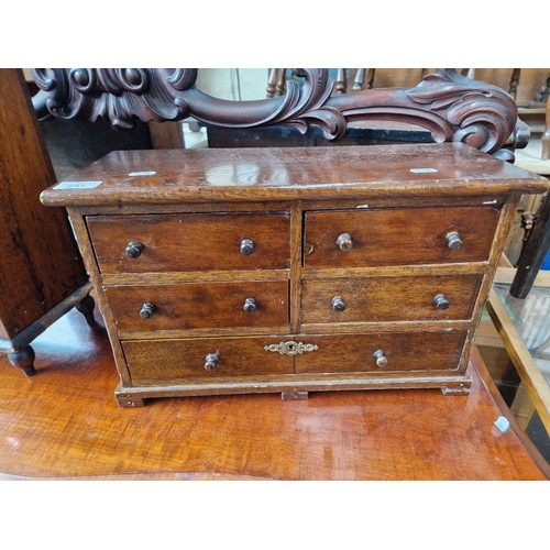 891 - A Victorian mahogany and oak miniature chest of drawers.