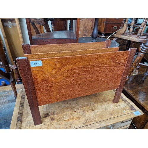 897 - A mid 20th century teak magazine rack.