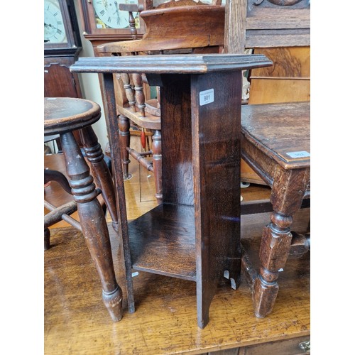 901 - An Arts & Crafts oak occasional table/plant stand, label for Pioneer Stores, Liverpool to underside.