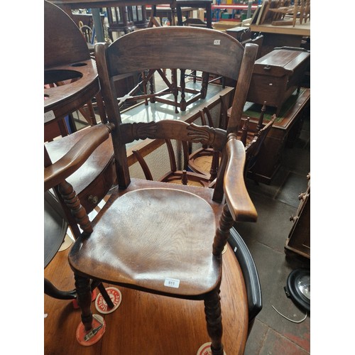 911 - A 19th century beech and elm armchair.