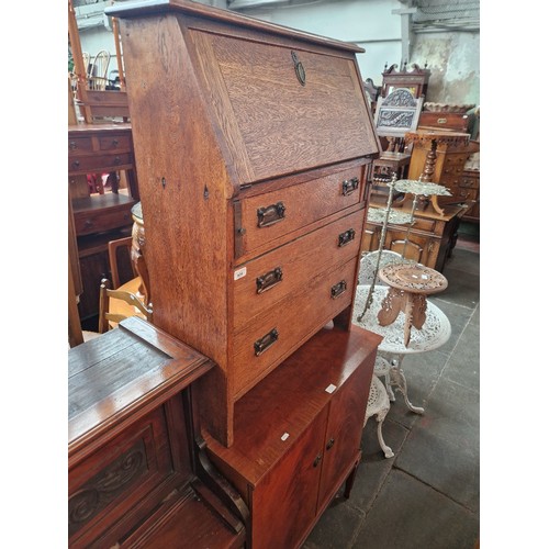 924 - An early 20th century oak bureau and a mahogany side cabinet.